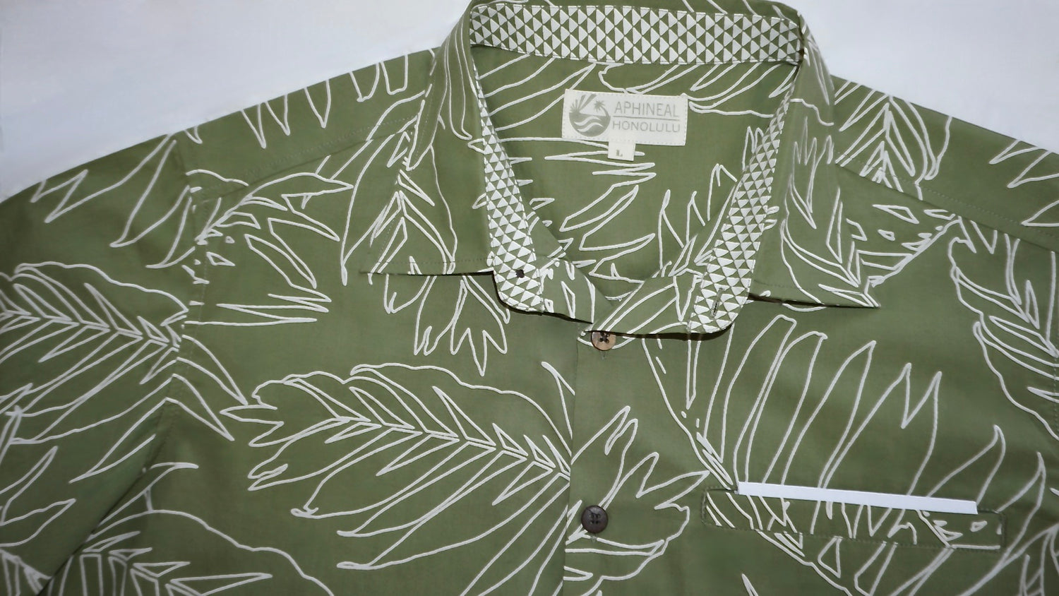 green men's shirt showing kapa print collar and welt pocket